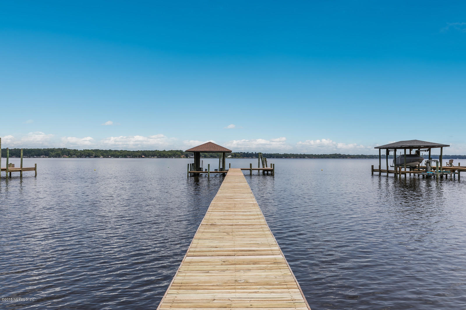 3130 Nautilus Road Middleburg, FL 32068 - Photo 46 of 67 a front view of a lake with table and chairs