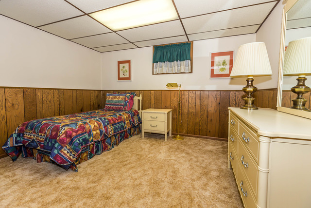 809 Overlook Drive Frankfort, IL 60423 - Photo 20 of 24 a bedroom with a bed a mirror and a flat screen tv