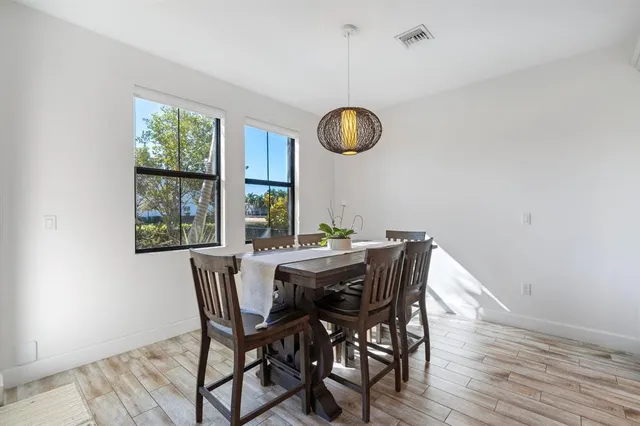 a view of a dining room with furniture window and wooden floor