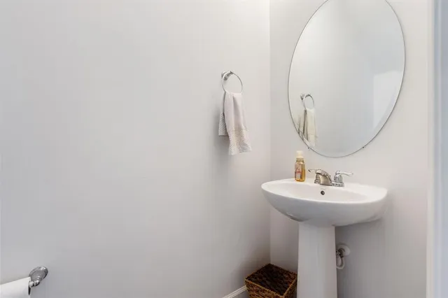 a bathroom with a sink a mirror and vanity
