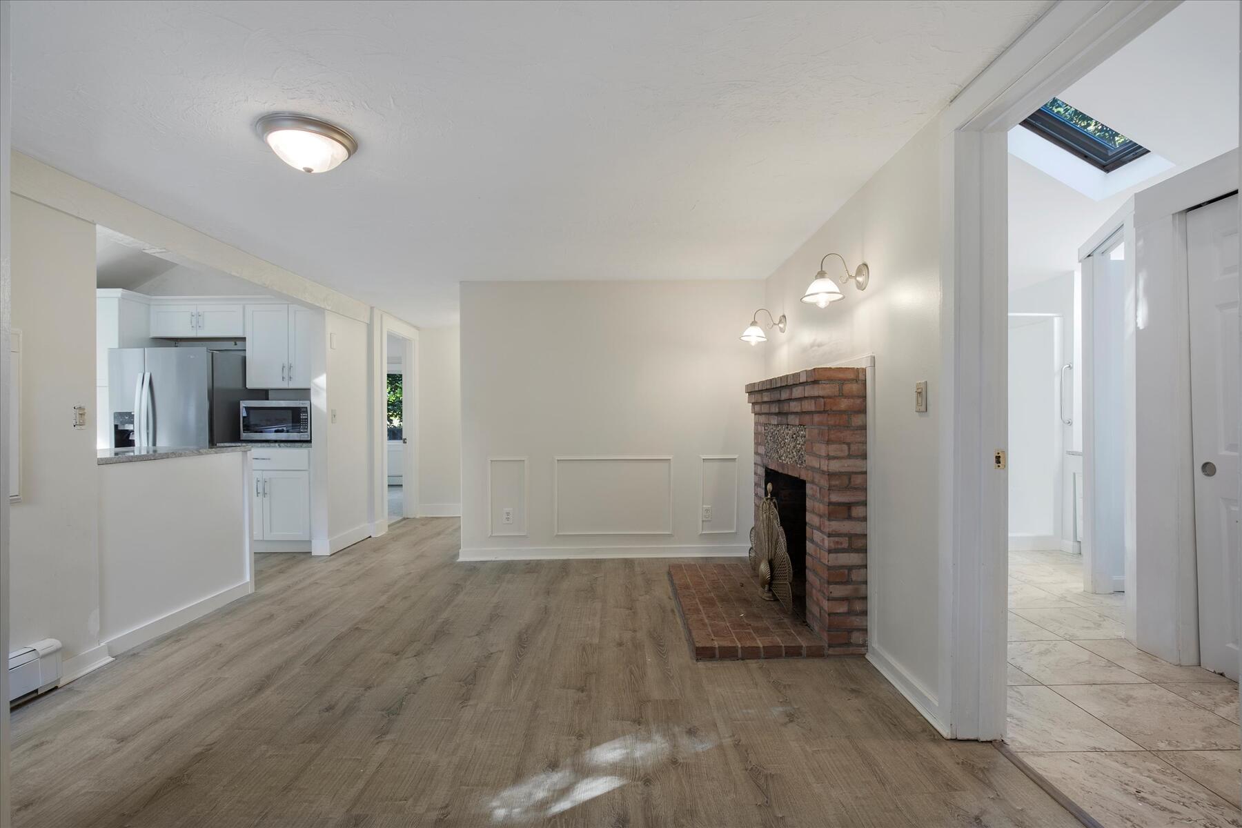 254 Barlows Landing Road Pocasset, MA 02559 - Photo 6 of 27 wooden floor in an empty room with a kitchen