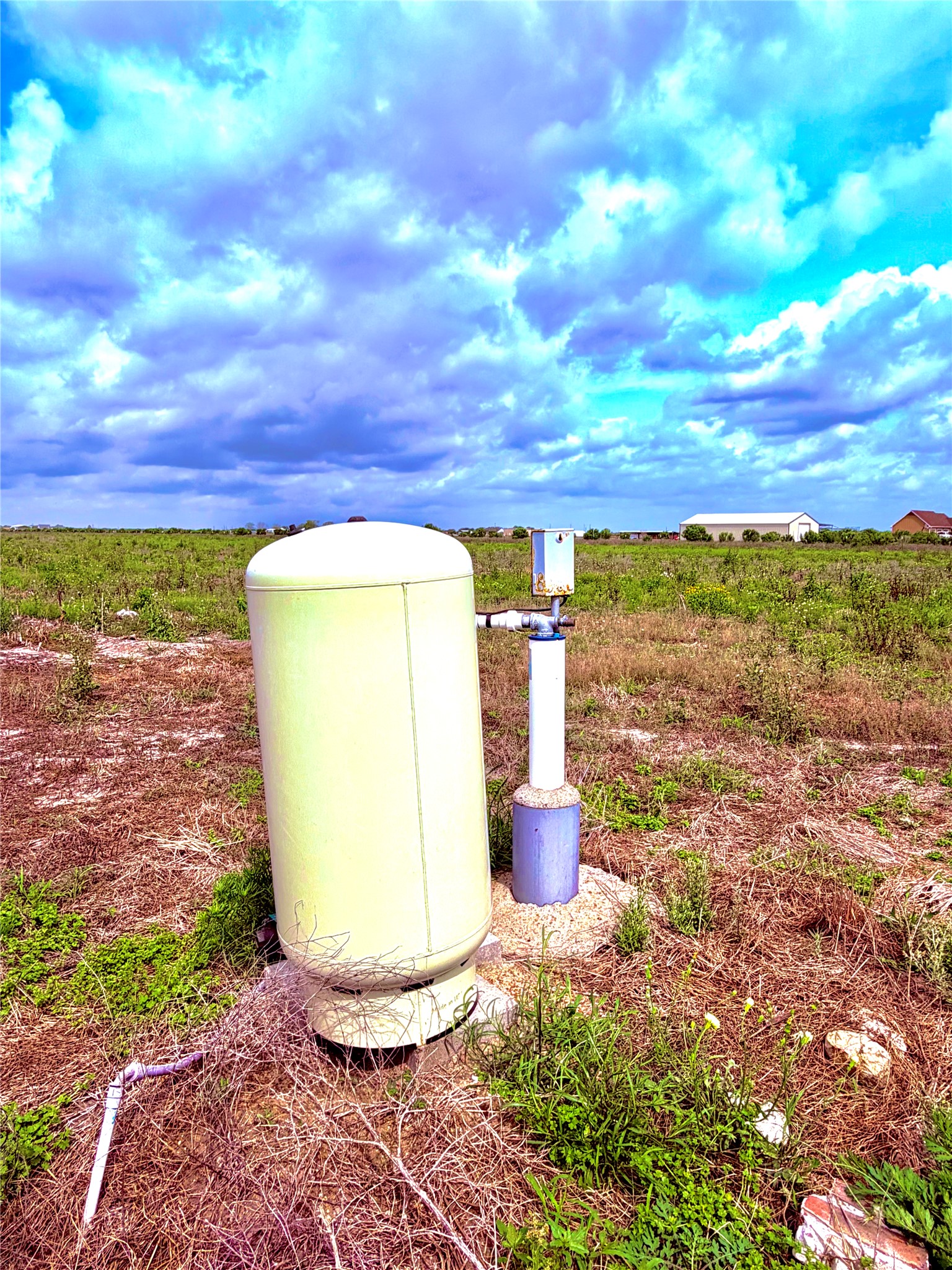 4421 Polak Road Wallis, TX 77485 - Photo 5 of 9 The property features an installed well system, visible with a beige pressure tank and a white well pipe