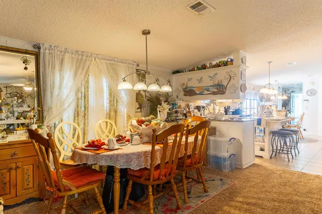 a bedroom with a bed and a flat tv screen on dresser