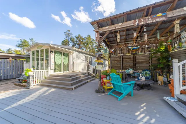 a bedroom with furniture and large windows