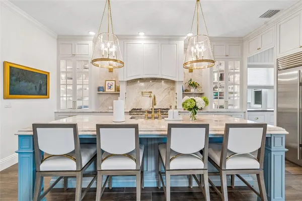 a kitchen with stainless steel appliances granite countertop a stove and a white cabinets