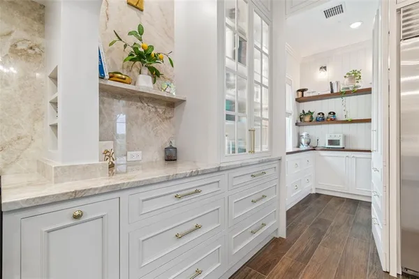a kitchen with granite countertop a sink and cabinets