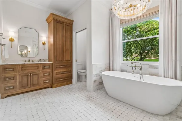 a bathroom with a granite countertop toilet sink and mirror