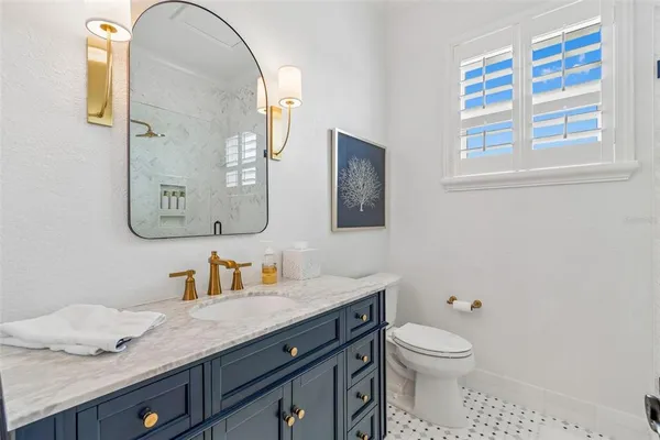 a bathroom with a toilet a sink and a window