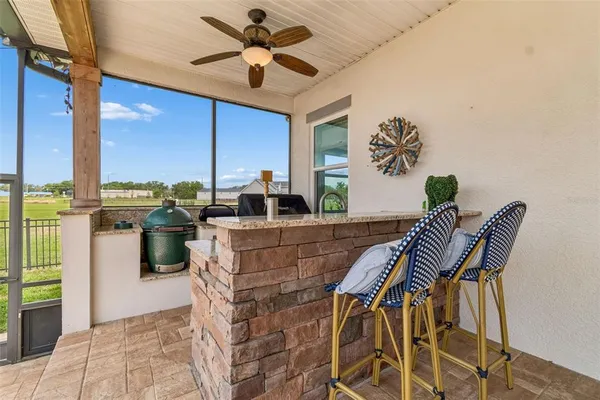 a view of a porch with furniture and a yard