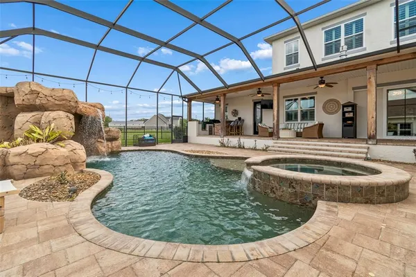 a kitchen with stainless steel appliances a refrigerator a stove a sink dishwasher and white cabinets with wooden floor