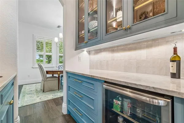 a kitchen with granite countertop a sink stove and refrigerator