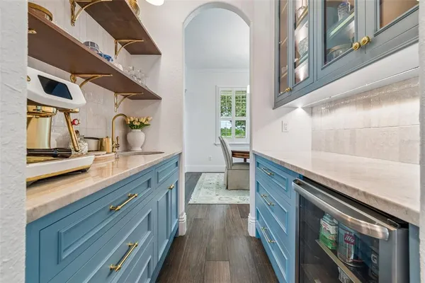 a view of a dining room with furniture a chandelier and wooden floor