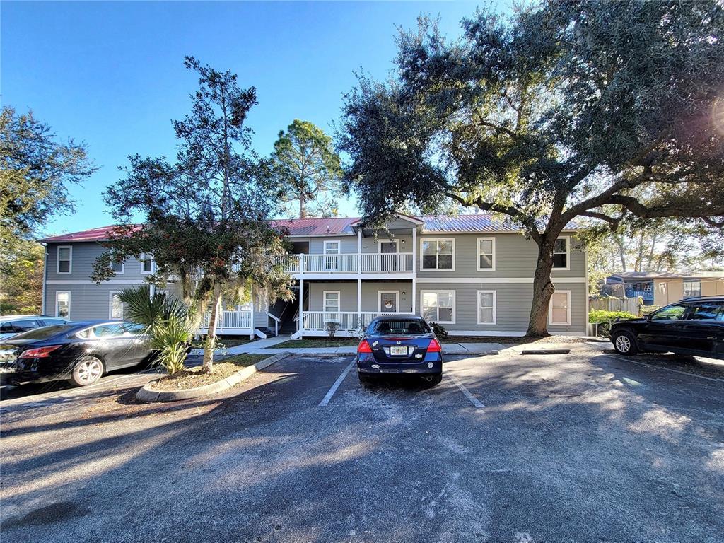 2905 Southwest Archer Road, Unit 5026 Gainesville, FL 32608 - Photo 1 of 1 a car parked in front of the building