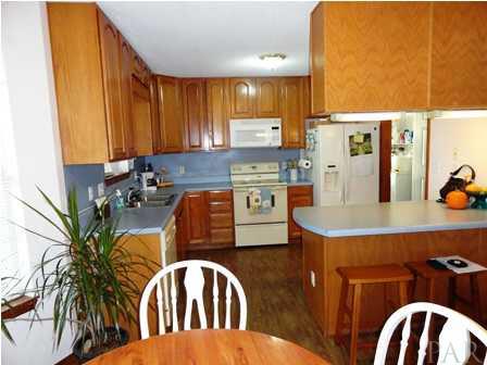 1950 Smyers Road Cantonment, FL 32533 - Photo 14 of 25 a kitchen with stainless steel appliances kitchen island granite countertop a table chairs in it and wooden floor