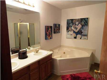 1950 Smyers Road Cantonment, FL 32533 - Photo 18 of 25 a bathroom with a tub sink and mirror