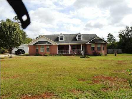 1950 Smyers Road Cantonment, FL 32533 - Photo 2 of 25 a front view of a house with a yard