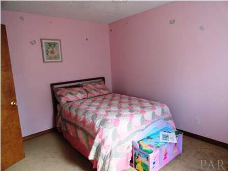 1950 Smyers Road Cantonment, FL 32533 - Photo 23 of 25 a bedroom with a bed and a couch