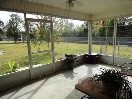 1950 Smyers Road Cantonment, FL 32533 - Photo 4 of 25 a view of a floor to ceiling window next to a yard