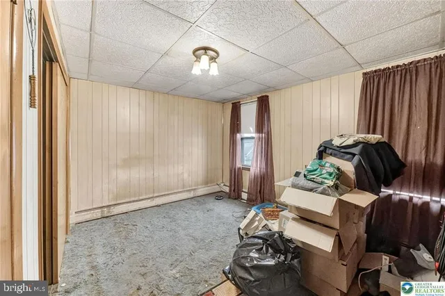 a view of a room that has a bed in it