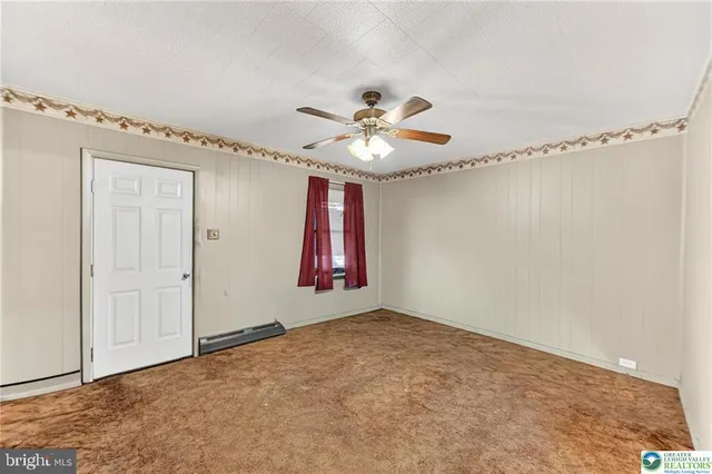 a view of a room with window and ceiling fan