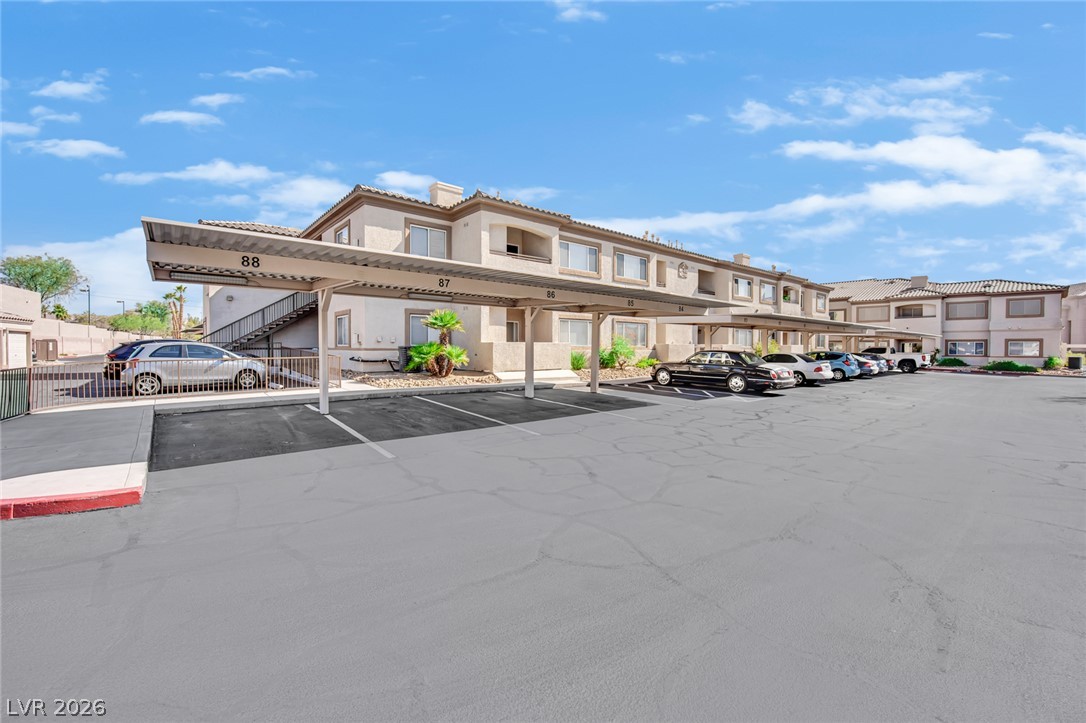 8725 West Flamingo Road, Unit 110 Las Vegas, NV 89147 - Photo 27 of 30 Secure covered parking alongside an inviting residential building.