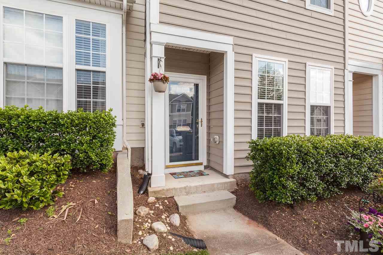 7815 Spungold Street Raleigh, NC 27617 - Photo 2 of 25 a front view of a building with a garden