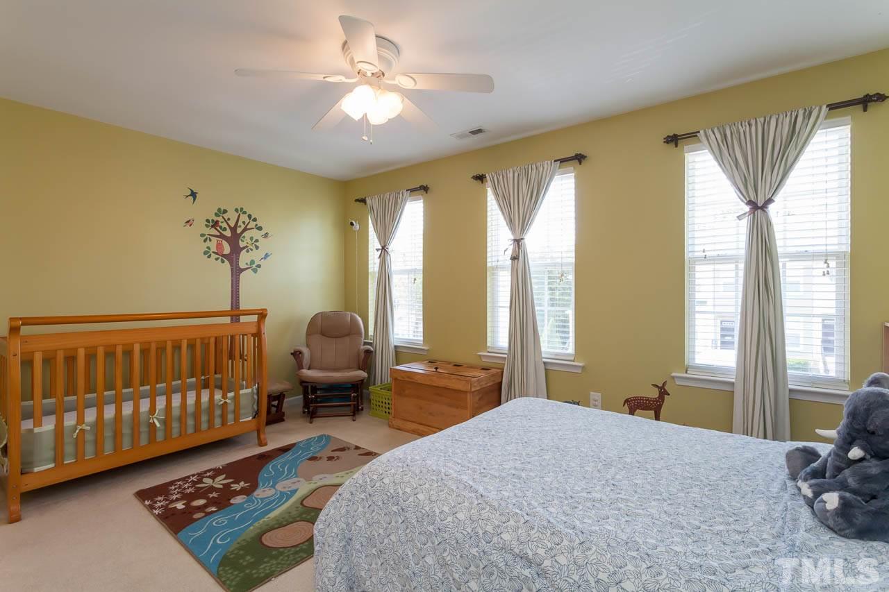 7815 Spungold Street Raleigh, NC 27617 - Photo 16 of 25 a bedroom with furniture and a window