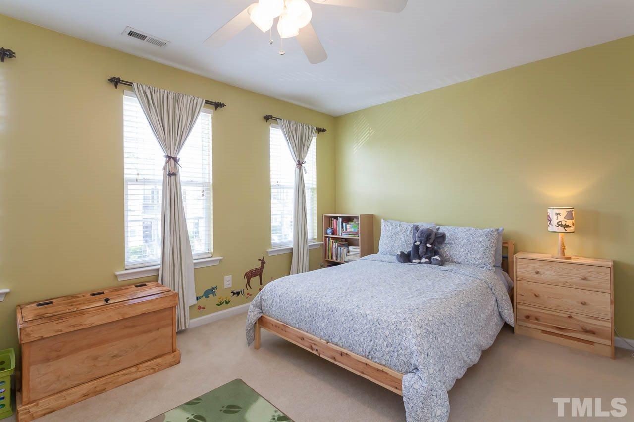 7815 Spungold Street Raleigh, NC 27617 - Photo 17 of 25 a bedroom with a bed and a window