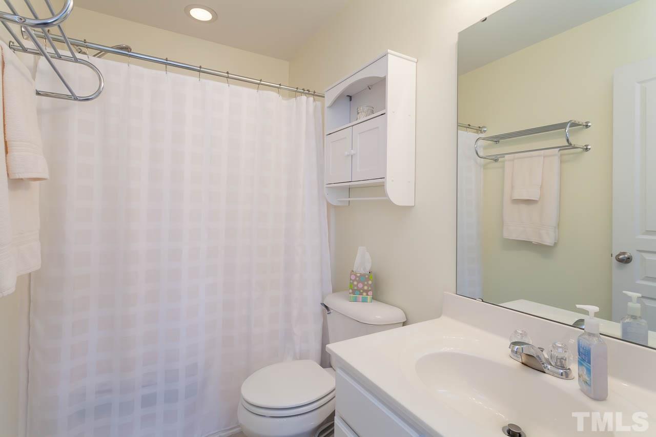 7815 Spungold Street Raleigh, NC 27617 - Photo 18 of 25 a bathroom with a sink toilet and shower