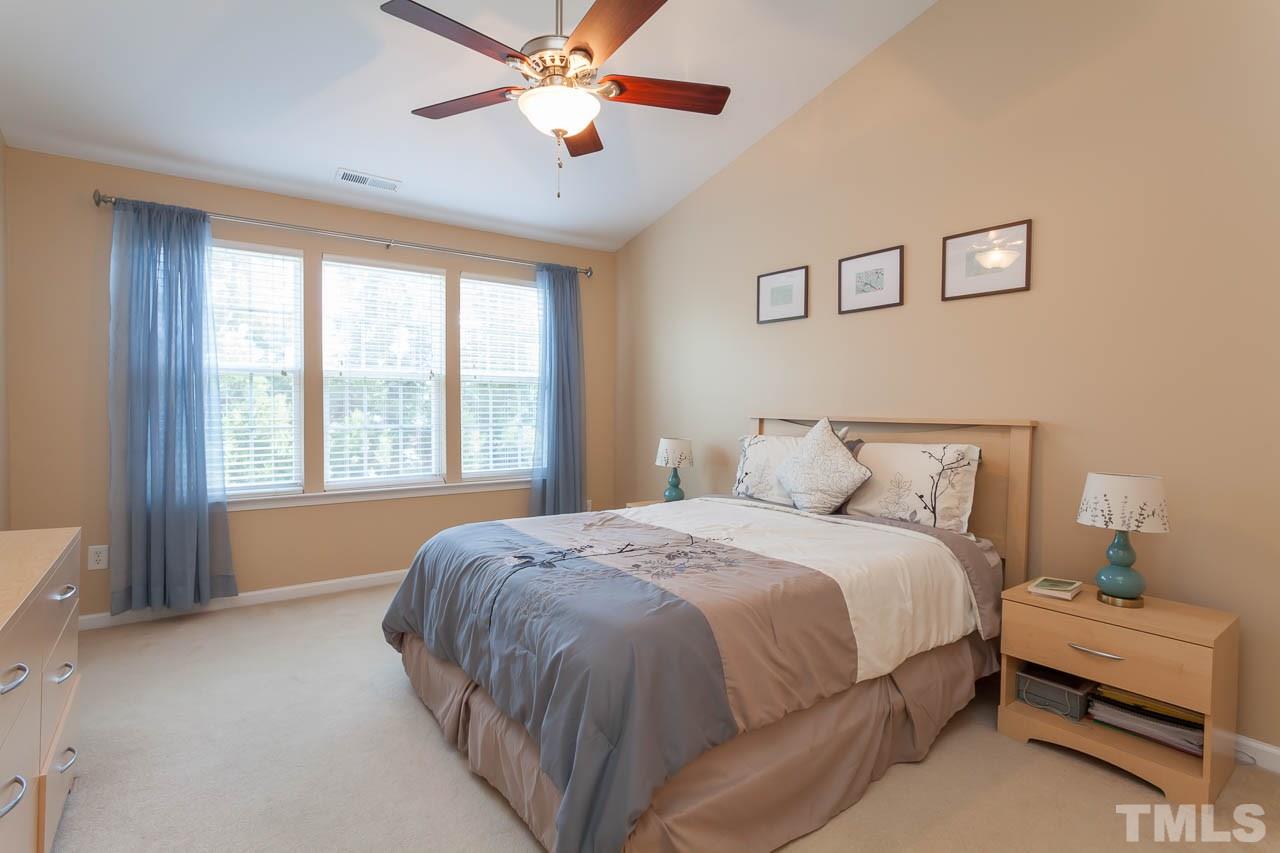 7815 Spungold Street Raleigh, NC 27617 - Photo 19 of 25 a spacious bedroom with a bed and a window
