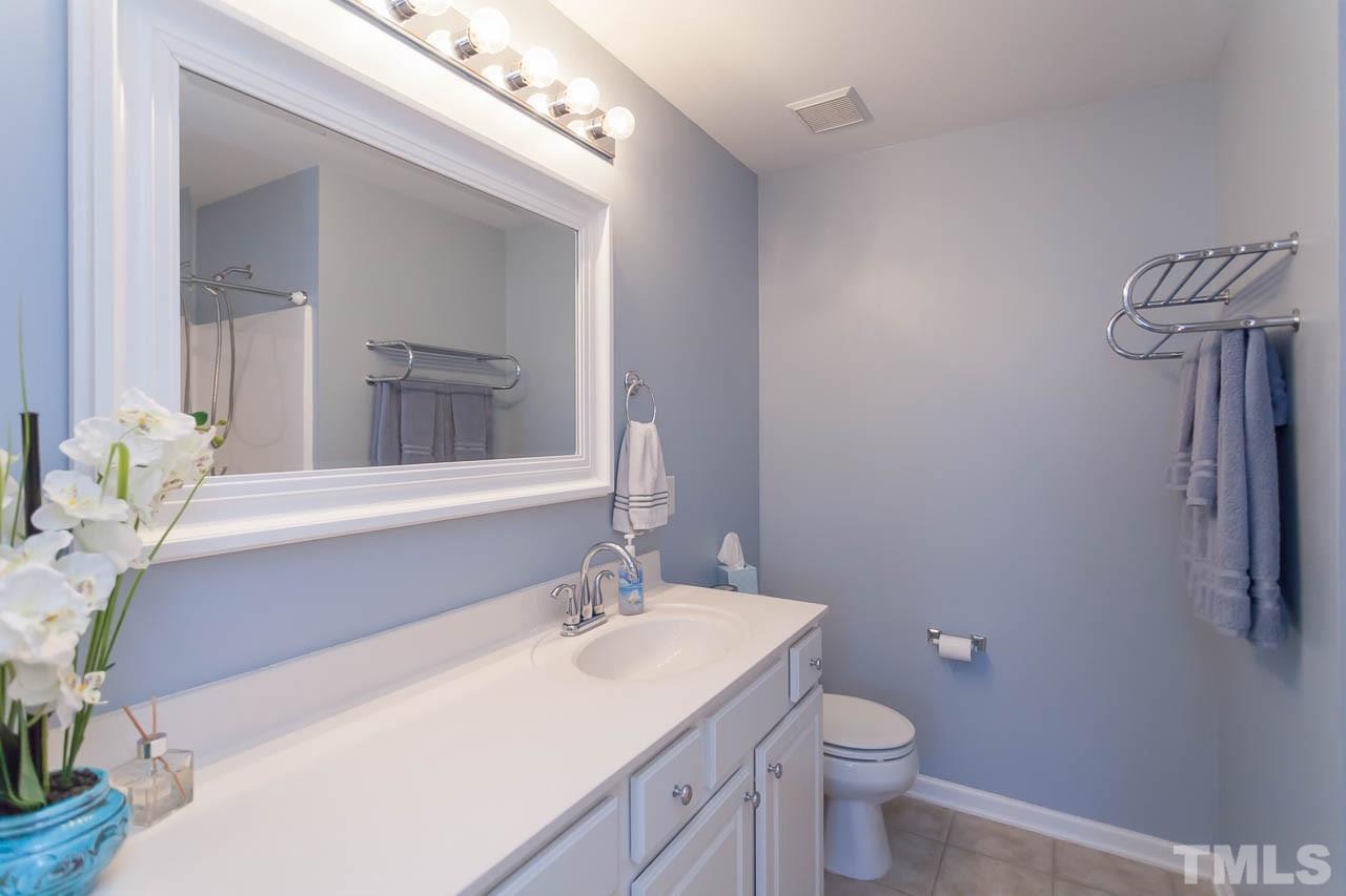 7815 Spungold Street Raleigh, NC 27617 - Photo 20 of 25 a bathroom with a sink a toilet and mirror