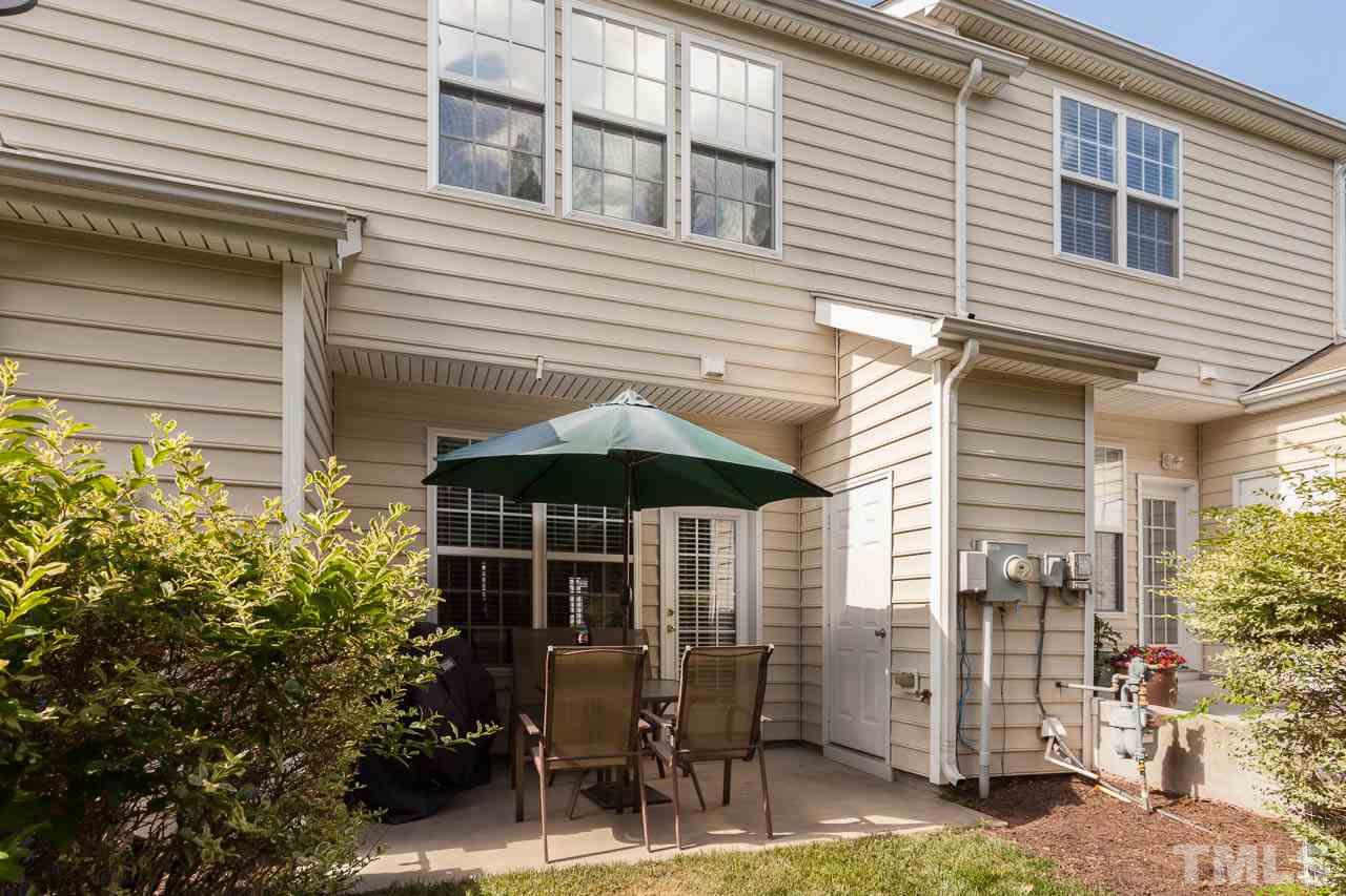 7815 Spungold Street Raleigh, NC 27617 - Photo 24 of 25 a table and chairs in front of a house