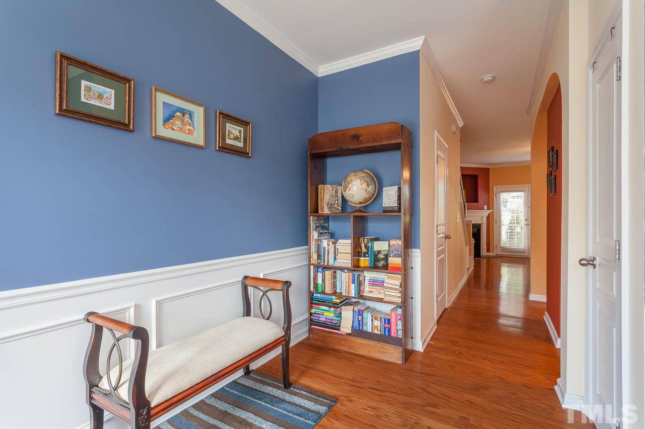 7815 Spungold Street Raleigh, NC 27617 - Photo 5 of 25 a view of a hallway with wooden floor and staircase
