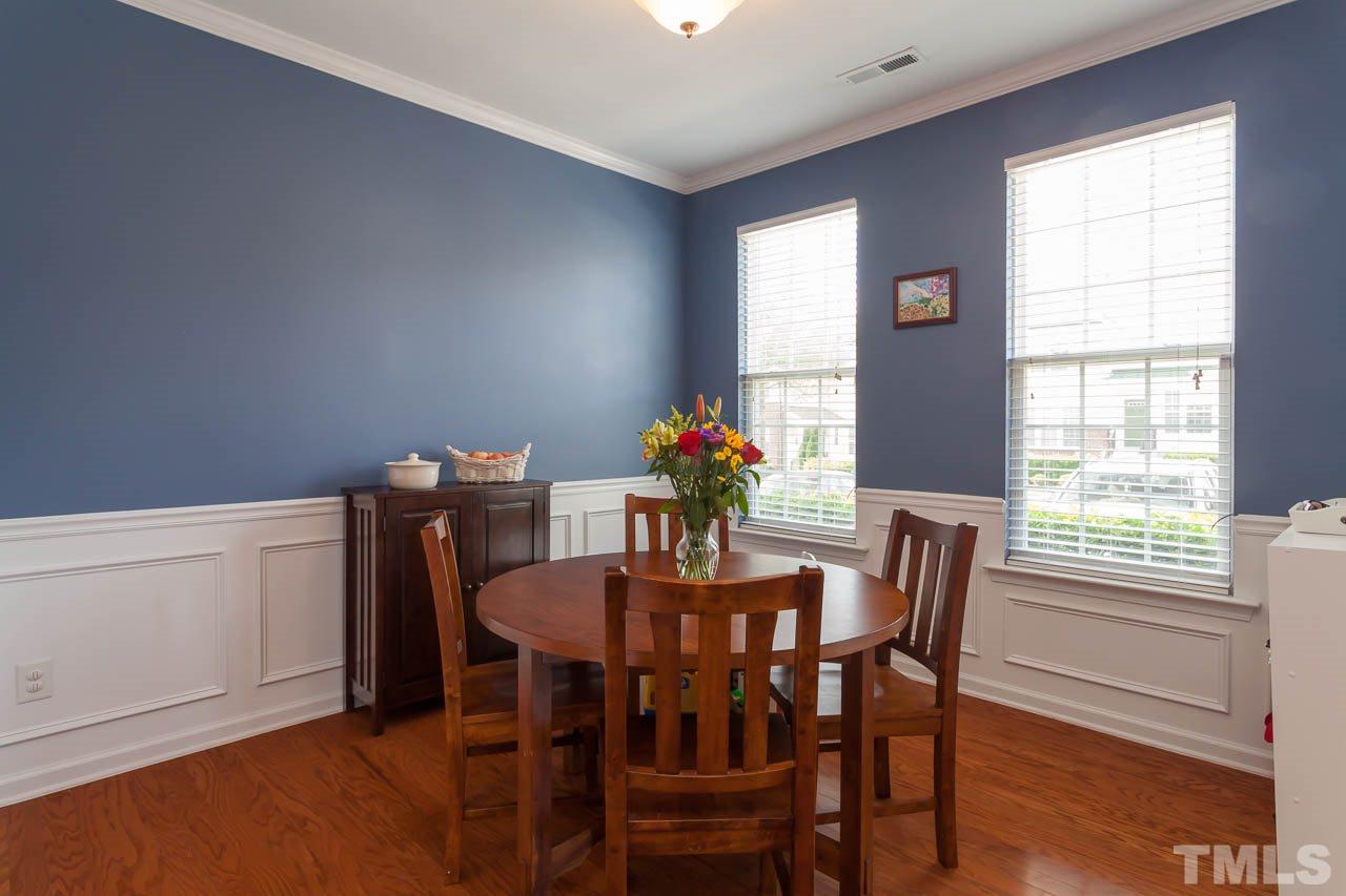 7815 Spungold Street Raleigh, NC 27617 - Photo 6 of 25 a view of a dining room with furniture and a potted plant