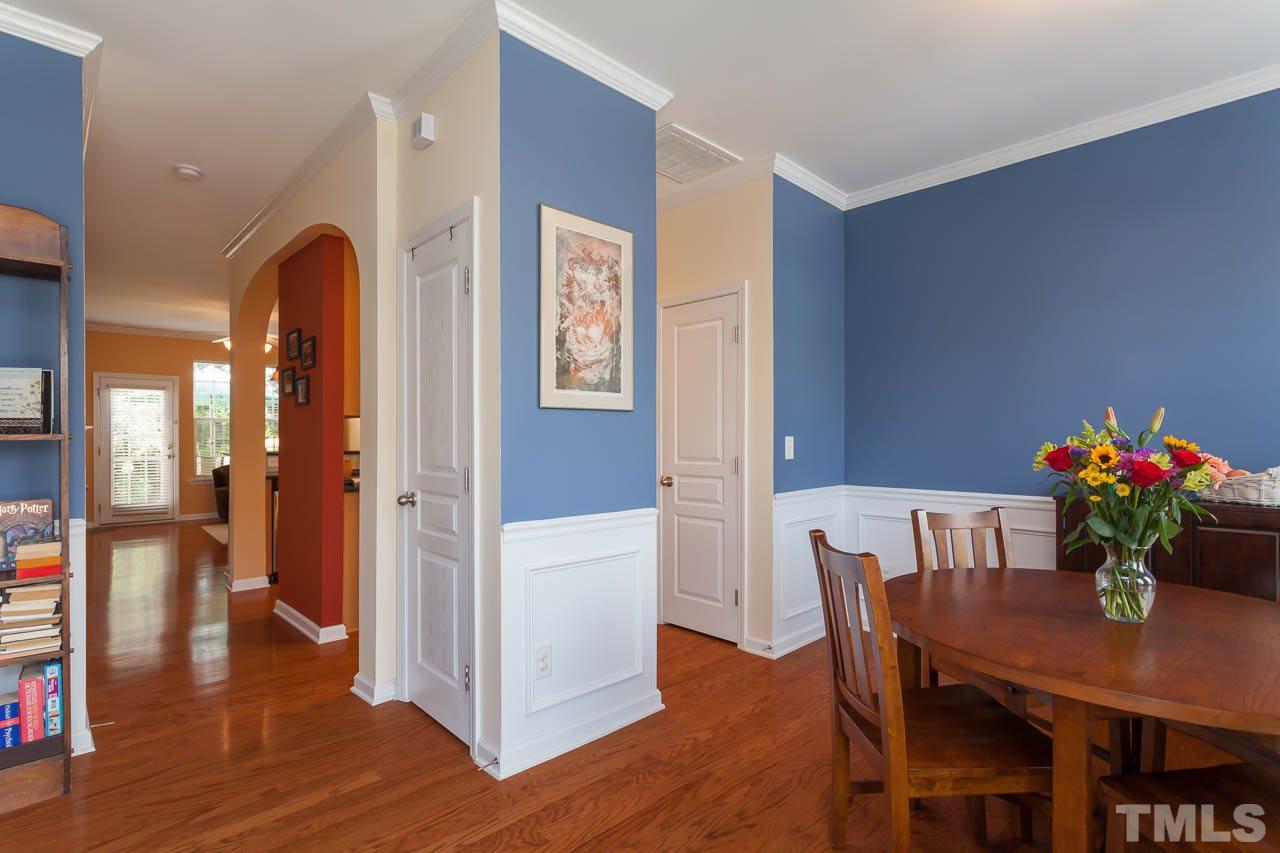 7815 Spungold Street Raleigh, NC 27617 - Photo 7 of 25 a view of a dining room with furniture and wooden floor