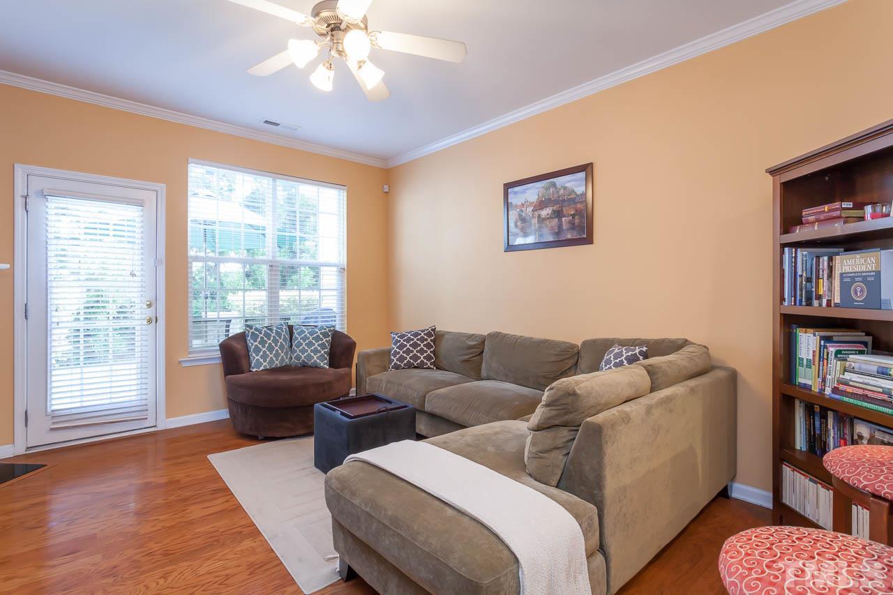7815 Spungold Street Raleigh, NC 27617 - Photo 8 of 25 a living room with furniture and a flat screen tv