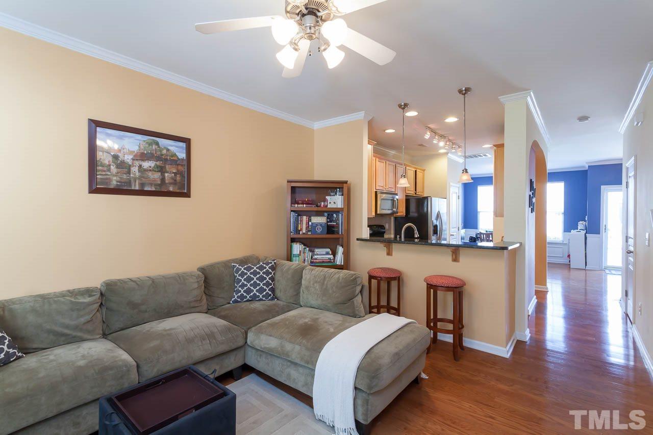7815 Spungold Street Raleigh, NC 27617 - Photo 10 of 25 a living room with furniture and kitchen view