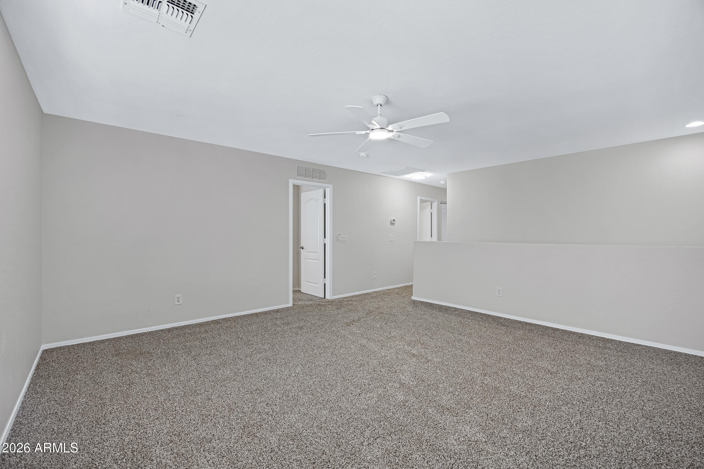 19408 North Braden Road Maricopa, AZ 85138 - Photo 29 of 51 a view of an empty room with a ceiling fan