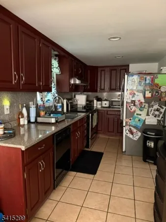 a kitchen with stainless steel appliances granite countertop a stove a sink dishwasher and a refrigerator