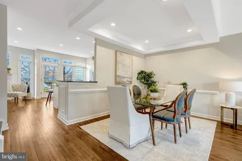 a view of kitchen with refrigerator and wooden floor