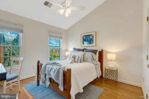 a view of staircase with white walls and a fireplace