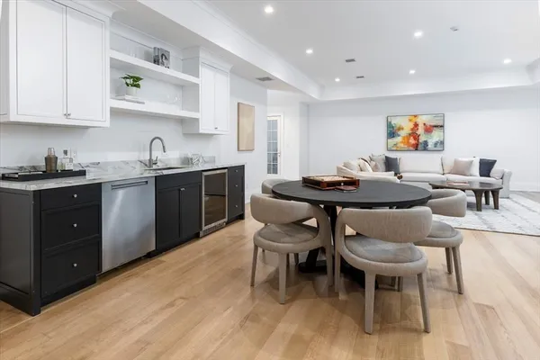 a kitchen with stainless steel appliances granite countertop a table and chairs in it
