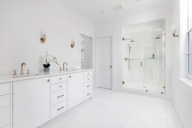 a bathroom with a double vanity sink and mirror