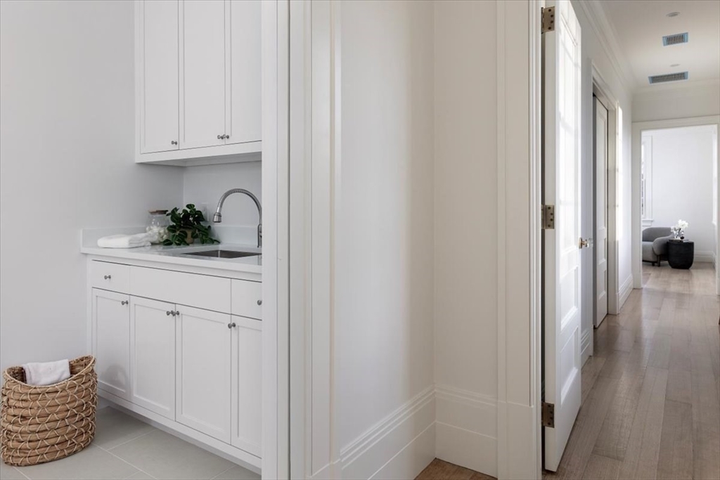 222 Warren Street Brookline, MA 02445 - Photo 20 of 33 a kitchen with a refrigerator and cabinets