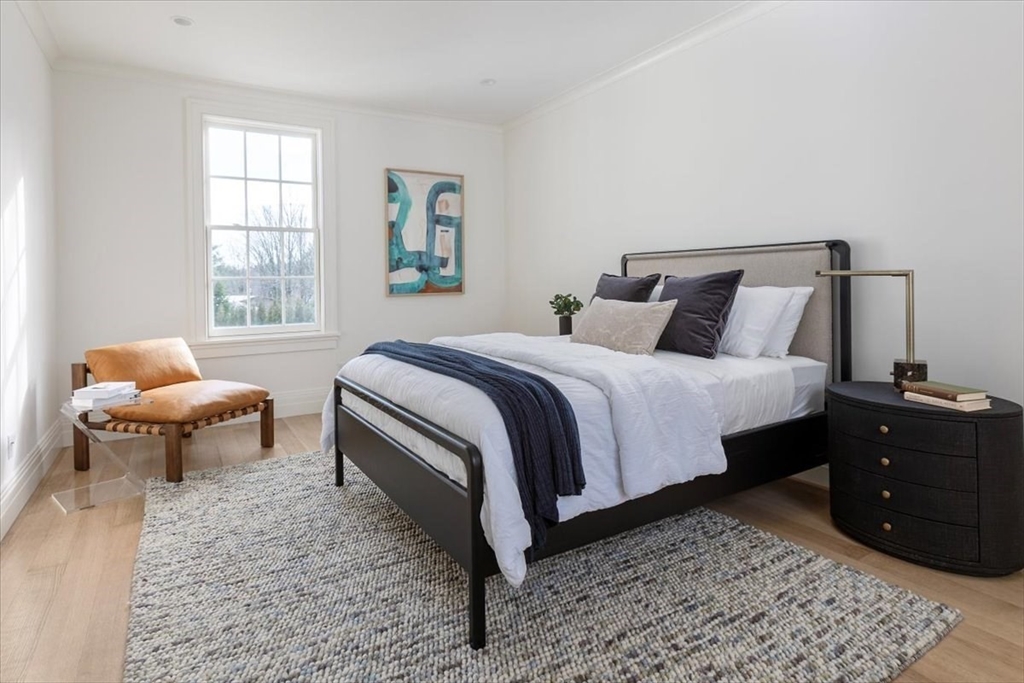 222 Warren Street Brookline, MA 02445 - Photo 21 of 33 a bedroom with a bed and wooden floor