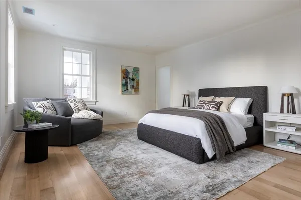 a bedroom with a bed and a couch