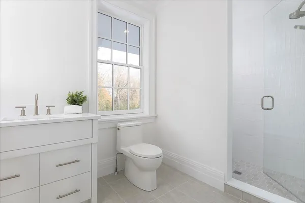 a bathroom with a toilet sink and window