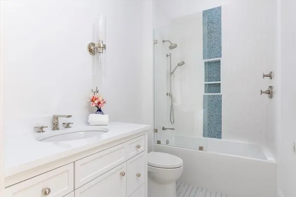 a bathroom with a sink toilet tub and shower