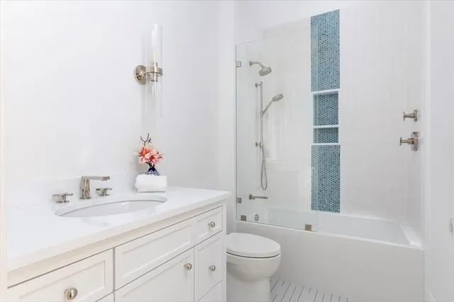 a bathroom with a sink toilet tub and shower