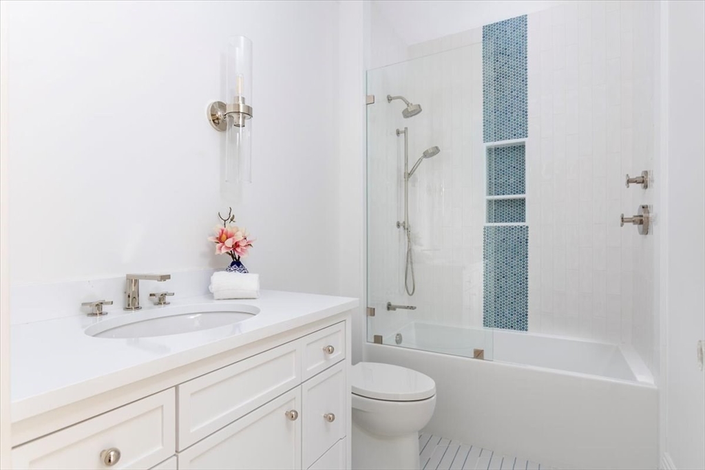 222 Warren Street Brookline, MA 02445 - Photo 28 of 33 a bathroom with a sink toilet tub and shower